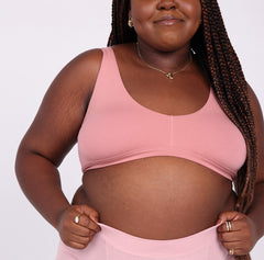 Load image into Gallery viewer, Size 2xl Woman showing back view of rose organic cotton fabric scoop bralette.
No underwire, double lined, soft boning for support and lace detail