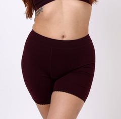 Load image into Gallery viewer, Woman wearing high rise organic cotton boxer underwear in black cherry
Breathable fabric, no pinch waistband, soft lace detail on leg