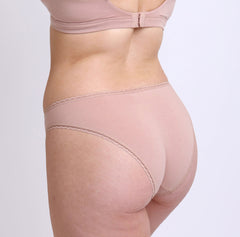 Load image into Gallery viewer, Size S Model wearing Certified Organic Cotton Nude Champagne Mid Rise Brief with cheeky bum coverage and breathable fabric