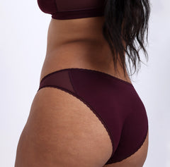 Load image into Gallery viewer, Size M Model showing back view of Organic Cotton Black Cherry Mid Rise Brief with mesh sides and cheeky coverage
