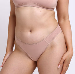 Load image into Gallery viewer, Size M model showing front view of Organic Cotton champagne nude Mid Rise Brief underwear
Soft breathable fabric, high cut leg