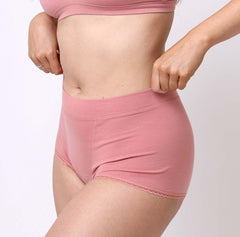 Load image into Gallery viewer, Size medium woman showing side view of certified organic cotton boyshort in desert rose color
Soft comfy fabric with no side seams