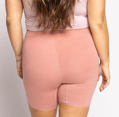 Load image into Gallery viewer, Back view of woman wearing high rise organic cotton boxer for women in desert rose pink color
