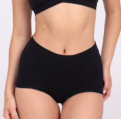 Load image into Gallery viewer, Size X-Small woman wearing certified organic cotton boyshort in black
No pinch waistband
No side seams