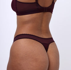 Load image into Gallery viewer, Woman wearing organic cotton mid rise thong underwear in medium back view