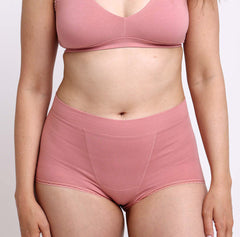 Load image into Gallery viewer, Size medium woman wearing super soft and comfy certified organic cotton boyshort in desert rose color