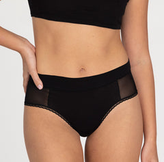 Load image into Gallery viewer, Woman wearing small la coochie organic cotton high rise brief underwear style with mesh panels