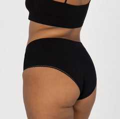 Load image into Gallery viewer, Back view of woman wearing high rise organic cotton briefs in all-cotton with lace detail and soft waistband
