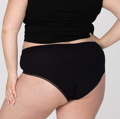 Load image into Gallery viewer, Back view of XXL woman wearing all organic cotton high rise brief underwear style in midnight black
