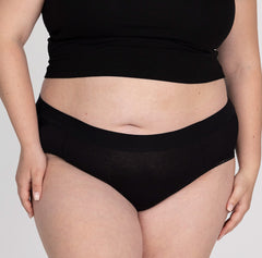 Load image into Gallery viewer, Front view of XXL woman wearing organic cotton high rise brief underwear in all-cotton black style
