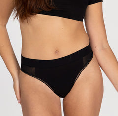 Load image into Gallery viewer, Front view of woman wearing midnight black high rise thong in organic cotton featuring mesh panels
