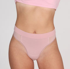 Load image into Gallery viewer, Front view of woman wearing blush pink organic cotton high waisted thong with mesh panels