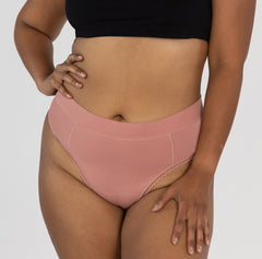 Load image into Gallery viewer, Front view of woman wearing organic cotton high rise thong in desert rose pink color made of organic cotton fabric 
