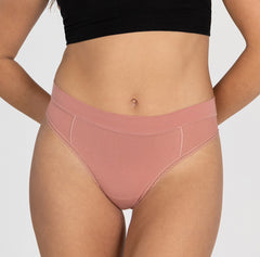 Load image into Gallery viewer, Front view of woman wearing high waisted thong in organic cotton fabric, featuring all-cotton style in desert rose pink
