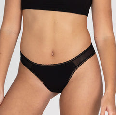 Load image into Gallery viewer, Size small model wearing mid rise brief underwear in la coochie organic cotton midnight black color
