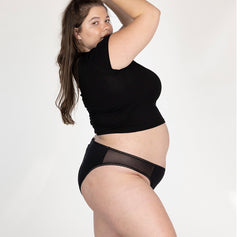 Load image into Gallery viewer, XXL woman side view wearing la coochie organic cotton mid rise brief in midnight black
