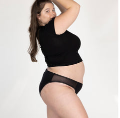 Load image into Gallery viewer, XXL woman side view wearing la coochie organic cotton mid rise brief in midnight black