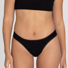 Load image into Gallery viewer, Size small model facing front wearing organic cotton midnight black mid rise brief underwear style, showing lace detail and all-cotton style
