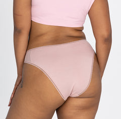 Load image into Gallery viewer, woman wearing la coochie cotton underwear in mid rise brief style facing the back to show off cheeky butt coverage and lace details

