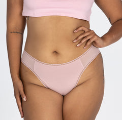 Load image into Gallery viewer, Woman wearing mid rise underwear style in blush pink brief front view, featuring lace detail and high cut leg
