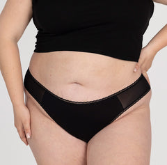 Load image into Gallery viewer, XXL model wearing la coochie mid rise thong in midnight black, lightweight breathable organic cotton fabric
