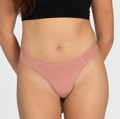 Load image into Gallery viewer, model wearing desert rose pink mid rise thong underwear in all organic cotton style
