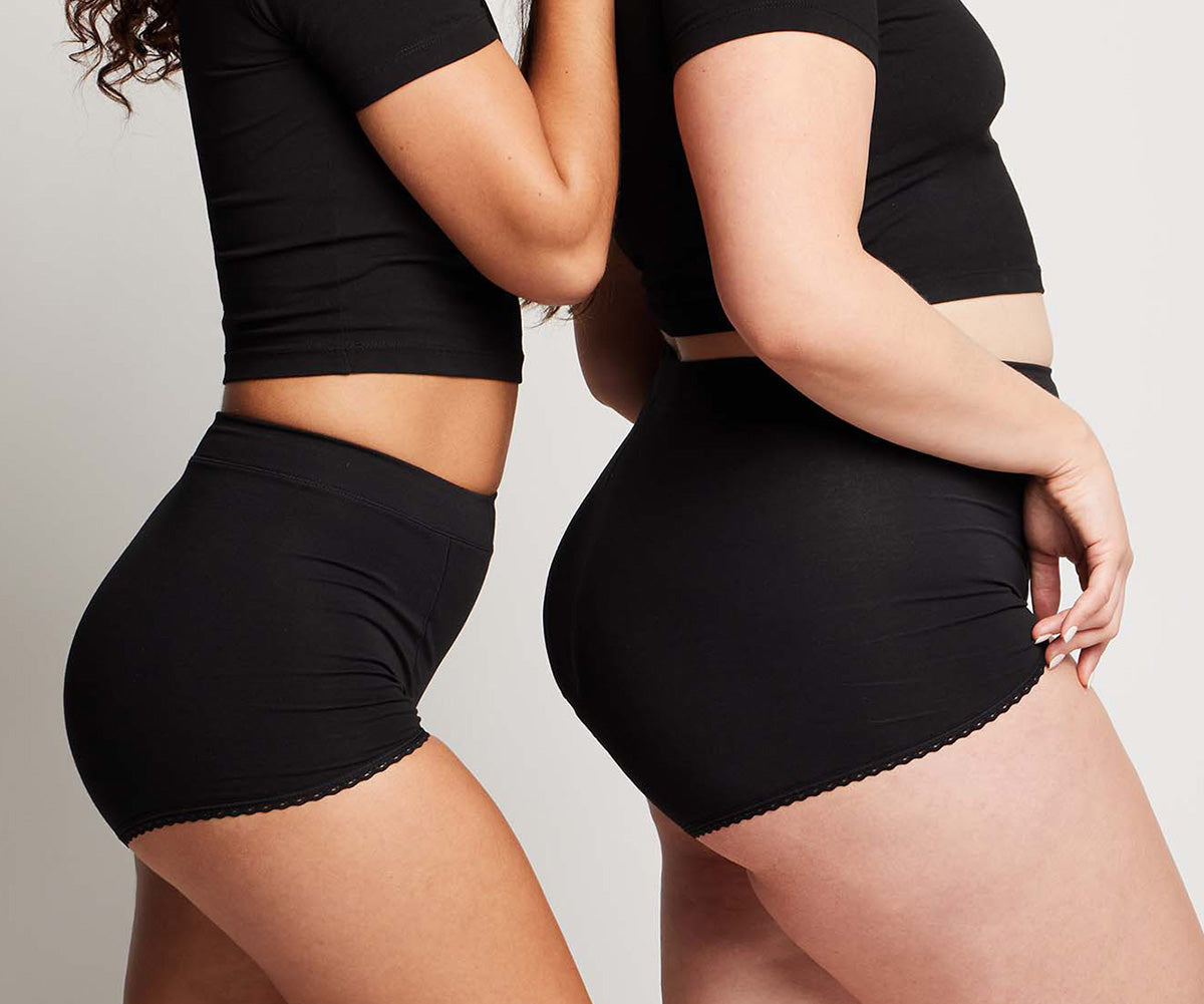 two women showing the side view of the organic cotton high rise boyshort with full coverage