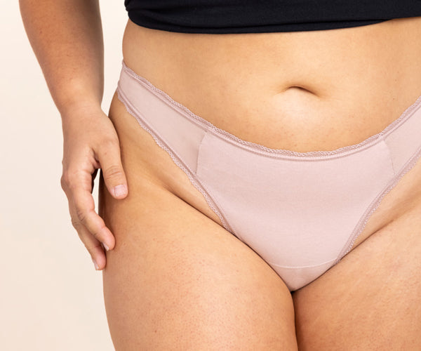 close up of woman wearing blush pink cotton mid rise brief with sexy non-toxic mesh panels