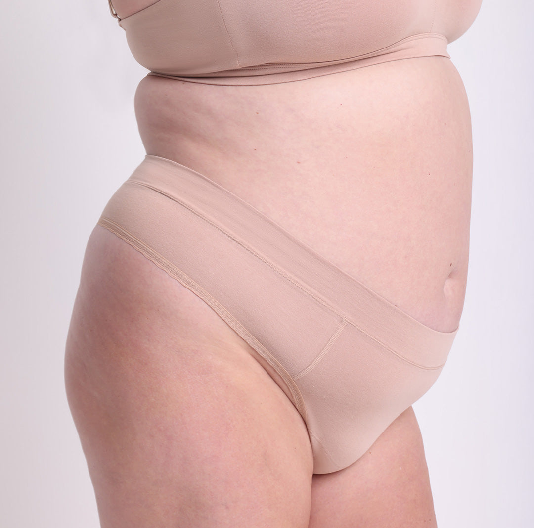 Size 2XL model showing front side view of organic cotton high rise thong in champagne
High waisted fit, breathable cotton fabric, longer gusset, non-toxic lace trim