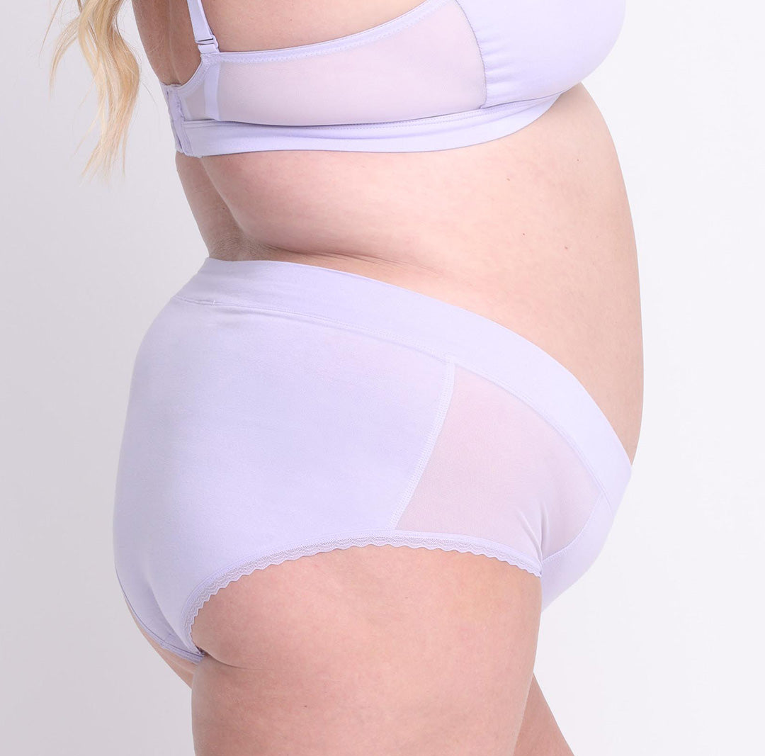 Size 2XL model showing back view of certified organic cotton high rise brief in lilac haze with mesh side panels
breathable, super soft cotton fabric with no side seams and cheeky coverage