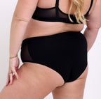 Size 2XL model showing back view of black high rise brief in organic cotton fabric 
No side seams, elastic-free waistband, non-toxic lace trim