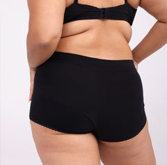 Load image into Gallery viewer, Size large woman showing back view of certified organic cotton high rise boyshort black
