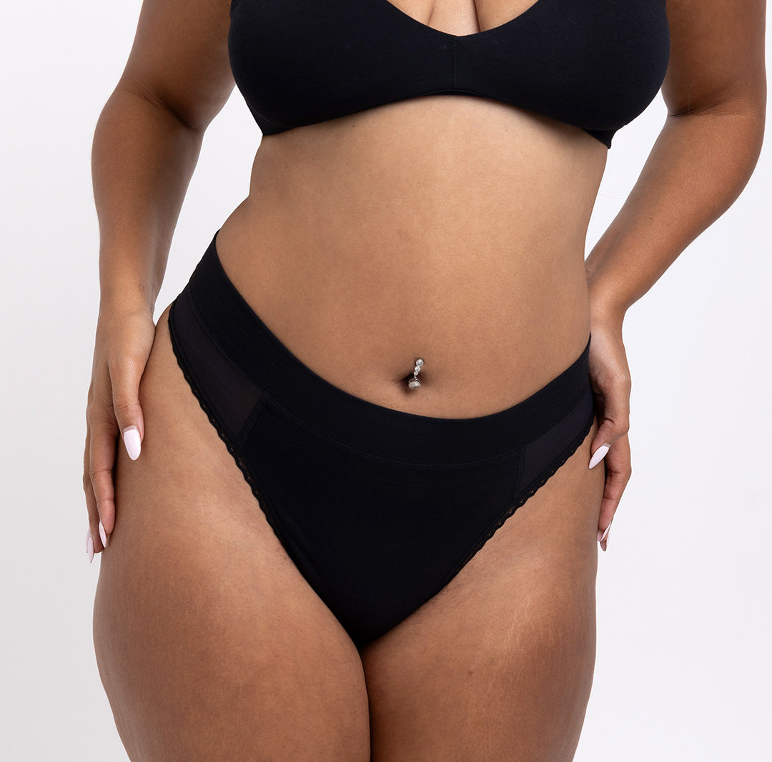 Size Large woman showing front view of organic cotton black high rise thong
High waisted fit, breathable cotton fabric, longer gusset, non-toxic lace trim
