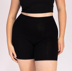 Load image into Gallery viewer, Woman showing front view of high rise organic cotton boxer underwear in black
Longer inseam, longer gusset, breathable cotton fabric
