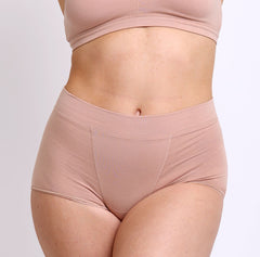 Load image into Gallery viewer, Size medium woman wearing certified organic cotton boyshort in champagne color
