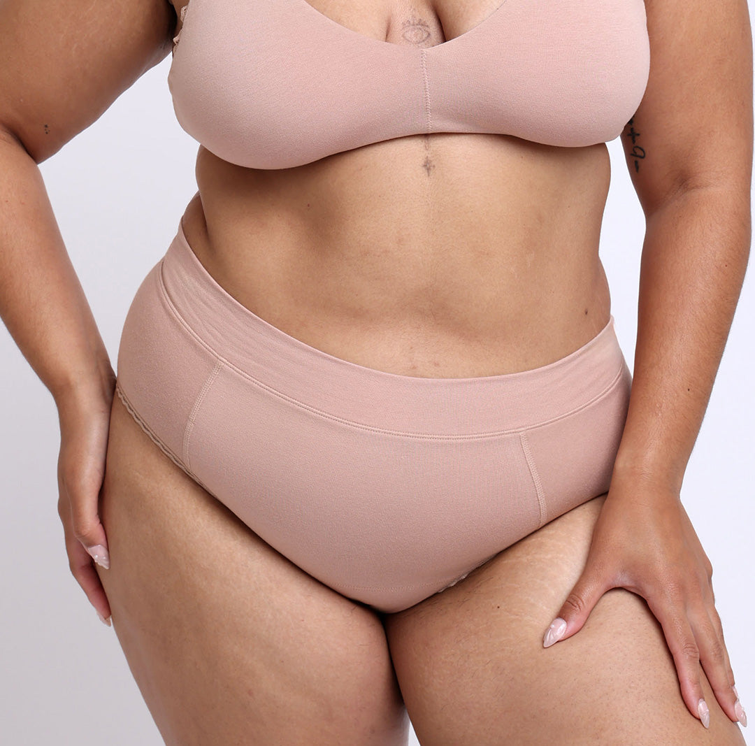 Front image of a large model wearing a high rise brief made from certified organic cotton in champagne
lightweight breathable material, smooth side-seam-free design, and elastic-free waistband