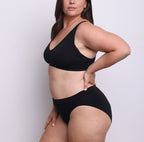 Size L model showing side view of organic cotton French-cut high brief in midnight black. Breathable, super soft organic cotton with a high French-cut leg