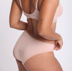 Size L model showing back view of organic cotton mid rise cheeky brief in champagne
Super soft, breathable cotton fabric with high cut sides and cheeky coverage