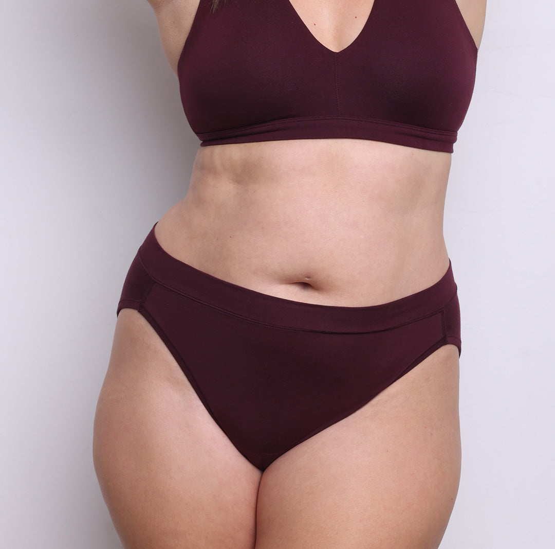 Size L model showing front view of organic cotton French-cut high brief in black cherry. Breathable, super soft organic cotton with a high French-cut leg