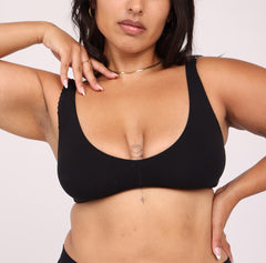 Load image into Gallery viewer, Size large Woman showing front view of soft organic cotton scoop bralette in midnight black with lace detail
