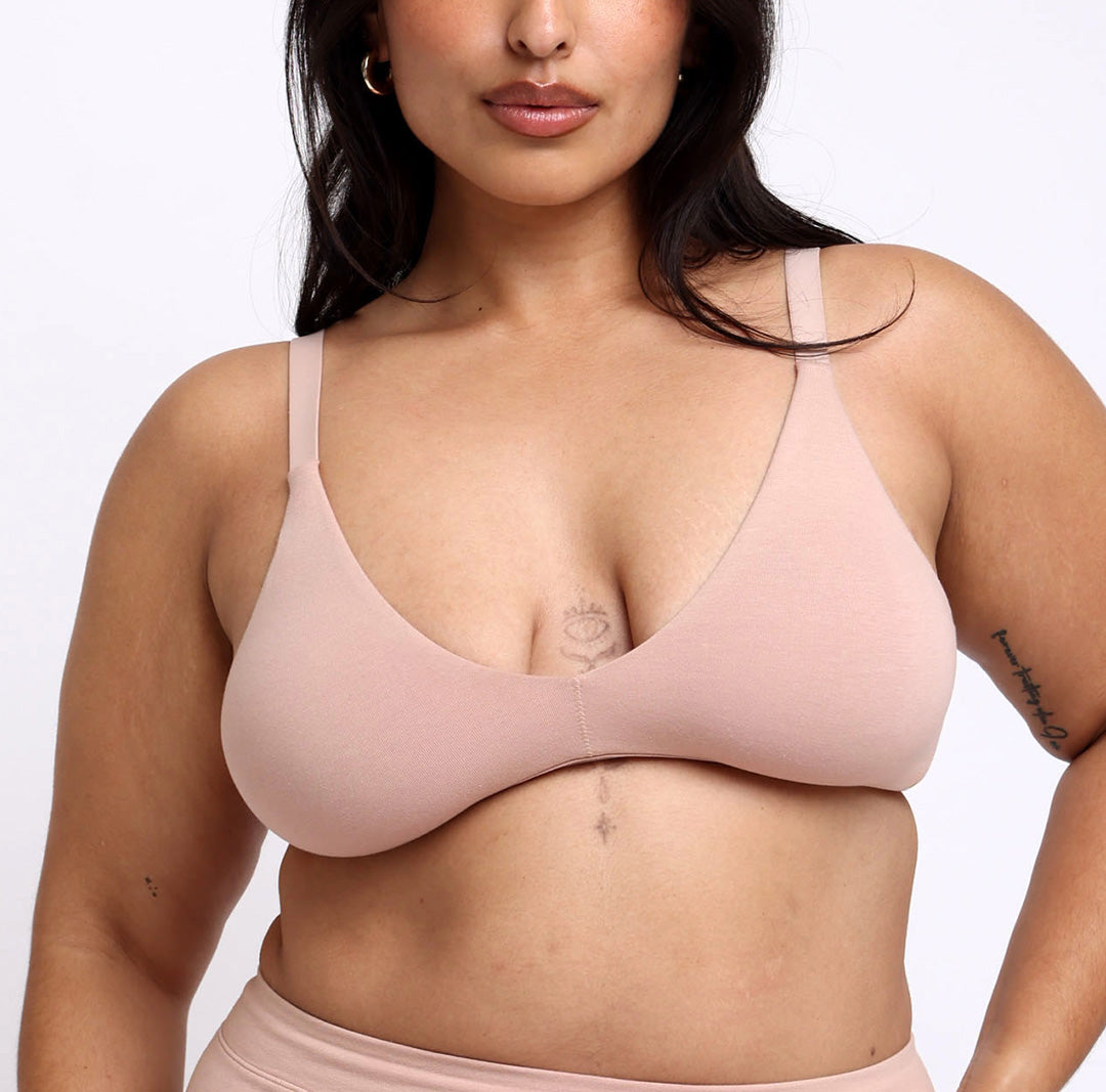 Woman wearing champagne certified organic cotton triangle bralette 
