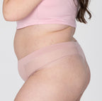 Size 2XL woman showing side view of organic cotton high rise thong in blush pink
High waisted fit, super soft cotton fabric, longer gusset, non-toxic lace trim