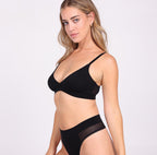 Woman wearing black organic cotton triangle bralette