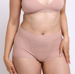 Load image into Gallery viewer, Size medium woman wearing certified organic cotton boyshort in champagne color
