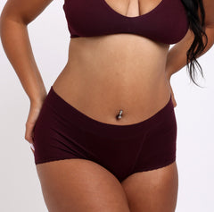 Load image into Gallery viewer, Size medium woman wearing high rise organic cotton boyshort in black cherry color
