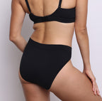 Size S model showing back view of organic cotton French-cut high brief in midnight black. Breathable, super soft organic cotton with a high French-cut leg