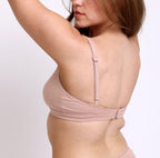 Size small Woman showing back view of certified organic cotton scoop neck bralette with adjustable straps & hook and eye closure