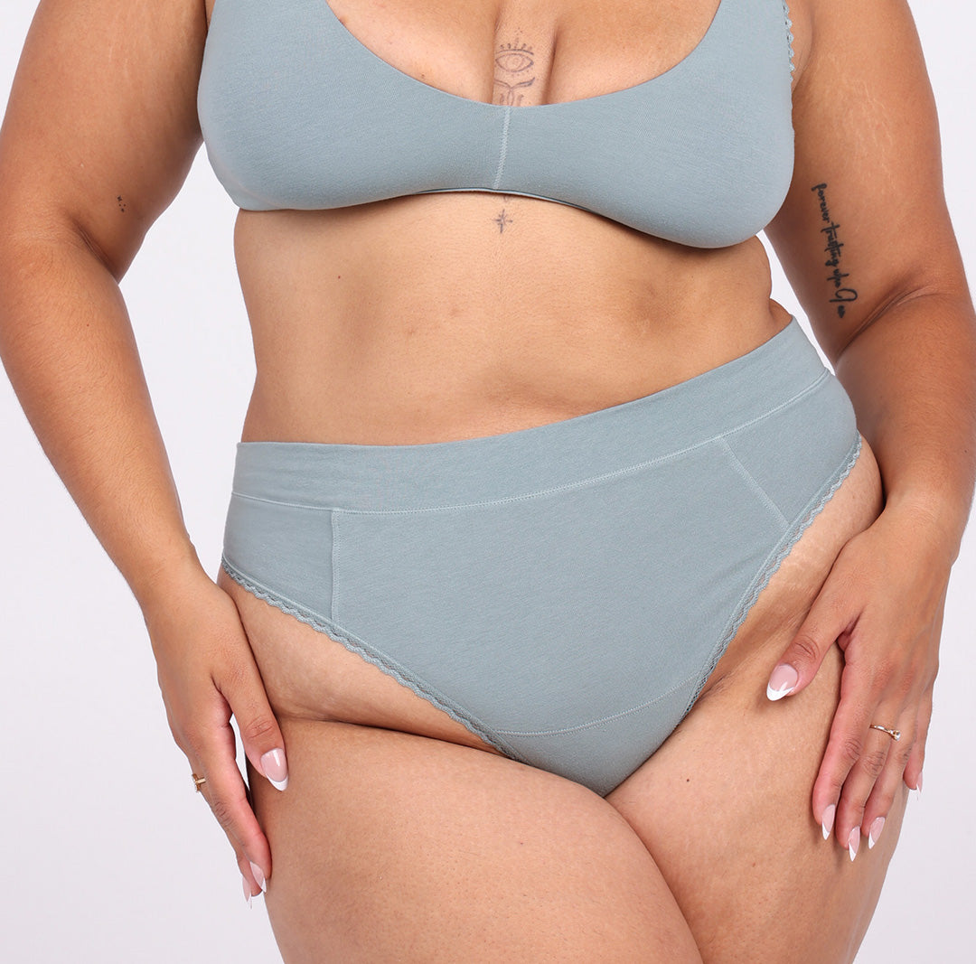 Size Large woman wearing sage organic cotton high rise thong with high cut leg 
Breathable fabric 