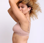Size small Woman showing side view of certified organic cotton fabric scoop bralette with lace detail