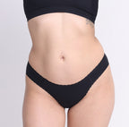 Size XS model showing front view of organic cotton mid rise cheeky brief in midnight black
Super soft, breathable cotton fabric with high cut sides and cheeky coverage
